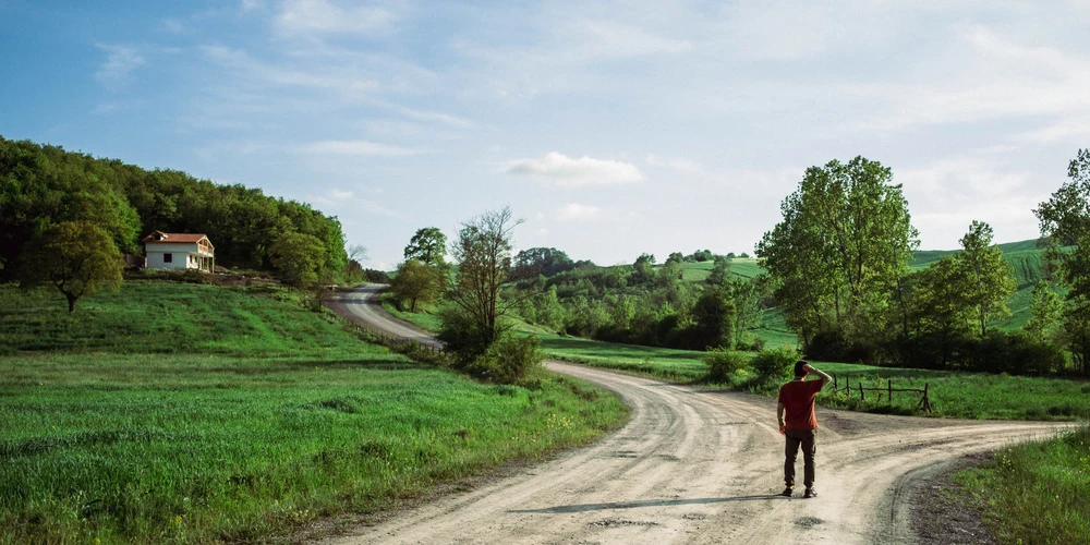 Person at a crossroads choosing between cash advance apps